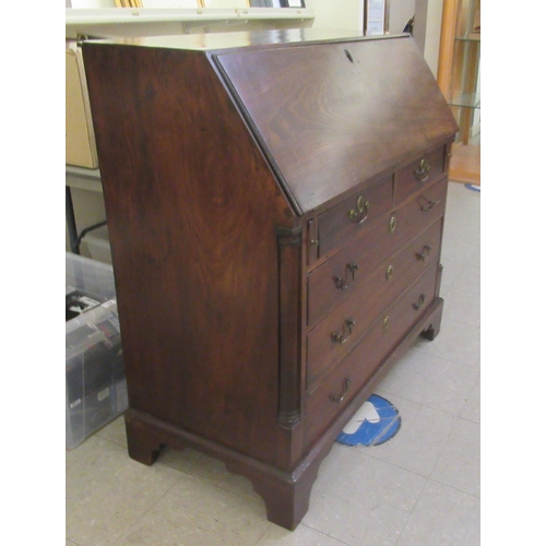 3 - A George III mahogany bureau with a fall front, enclosing a fitted interior, over two short/three gr... 