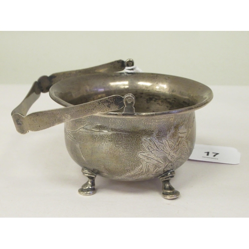 321 - A 1920s Chinese Zee Sung silver engraved sugar basin of cauldron form with a flared rim and swing ha... 