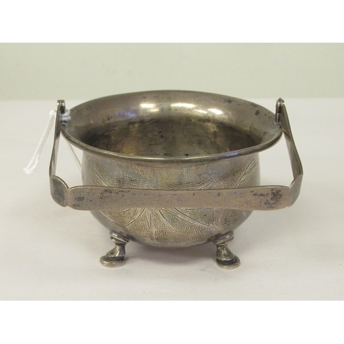 321 - A 1920s Chinese Zee Sung silver engraved sugar basin of cauldron form with a flared rim and swing ha... 