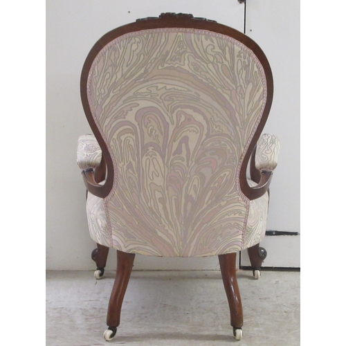 326 - A mid Victorian carved and moulded, showwood framed mahogany waisted spoonback chair with open arms,... 