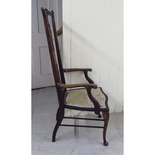 327 - An Edwardian mahogany framed string inlaid and marquetry hall chair, the high back with a yoke crest... 