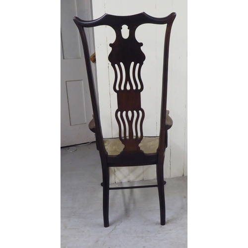 327 - An Edwardian mahogany framed string inlaid and marquetry hall chair, the high back with a yoke crest... 