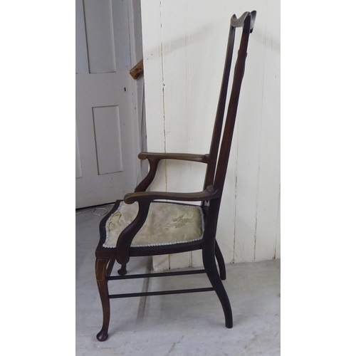 327 - An Edwardian mahogany framed string inlaid and marquetry hall chair, the high back with a yoke crest... 