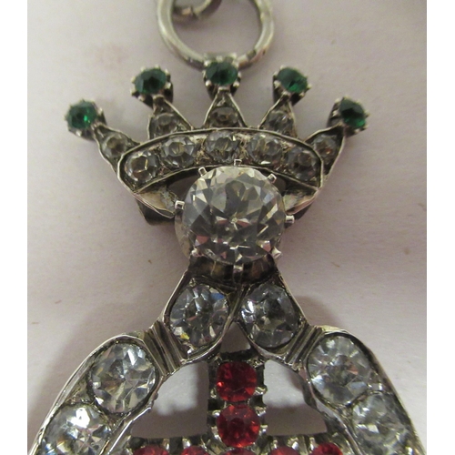 333 - A paste set white metal, hinged pendant, featuring a crown, over a cross and swan with spreading win... 