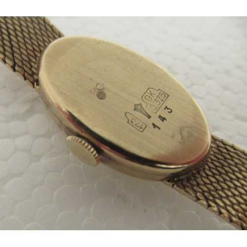 339 - A lady's Bueche Girod 9ct gold, oval cased bracelet wristwatch, faced by a baton dial