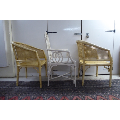 34 - A pair of simulated bamboo, cream wash painted, caned, framed chairs; and another dissimilar