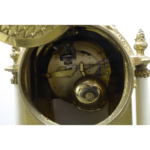 49 - A modern reproduction of a 19thC brass cased, three piece clock garniture; faced by a Roman dial  14... 