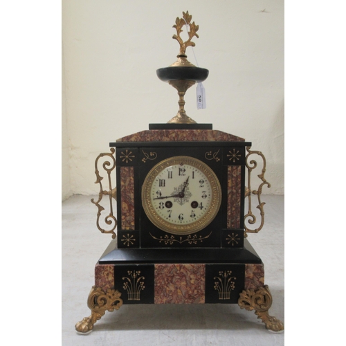 50 - An early 20thC marble and black slate cased mantel clock, on lion paw feet; faced by an Arabic dial ... 