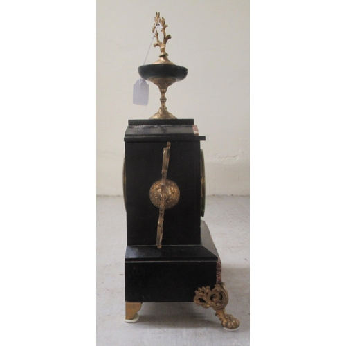 50 - An early 20thC marble and black slate cased mantel clock, on lion paw feet; faced by an Arabic dial ... 