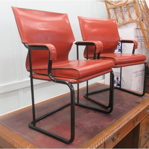 91 - A pair of Marcatre brown hide arm chairs, raised on black finished metal bases