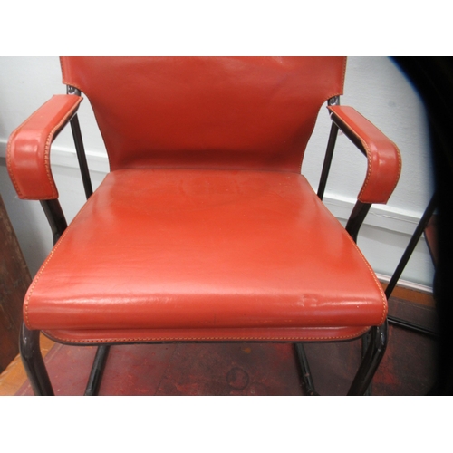 92 - A pair of Marcatre brown hide arm chairs, raised on black finished metal bases