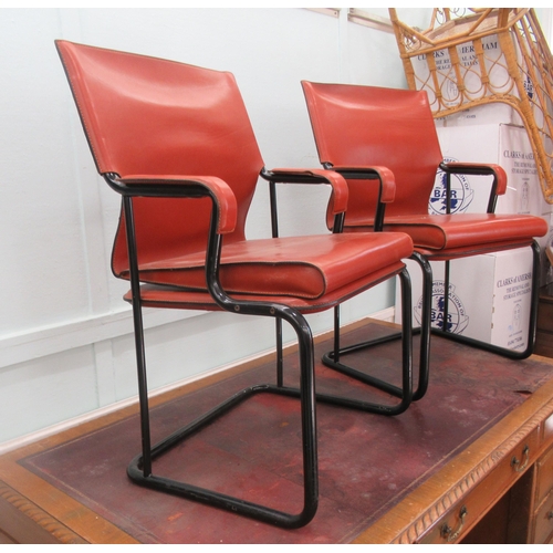 94 - A pair of Marcatre brown hide arm chairs, raised on black finished metal bases