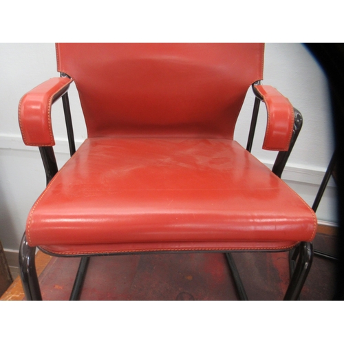 94 - A pair of Marcatre brown hide arm chairs, raised on black finished metal bases