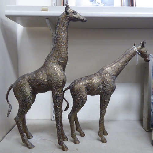 28 - Two similar African brass models, standing giraffes  23