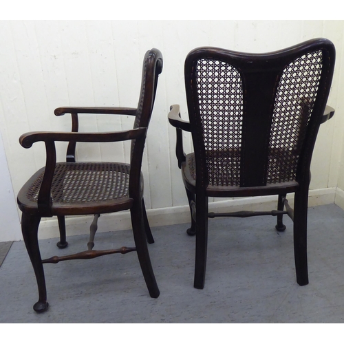 314 - A pair of 1930s stained beech framed bedroom chairs with caned backs and seats, raised on cabriole l... 