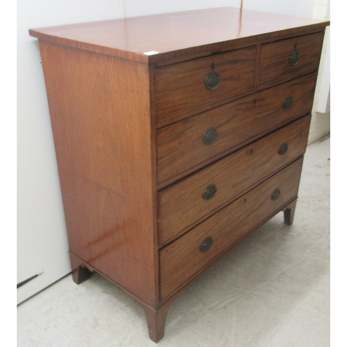 4 - An early 19thC mahogany dressing chest with two short/three graduated long drawers, raised on bracke... 