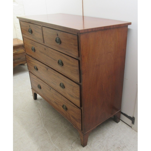 4 - An early 19thC mahogany dressing chest with two short/three graduated long drawers, raised on bracke... 