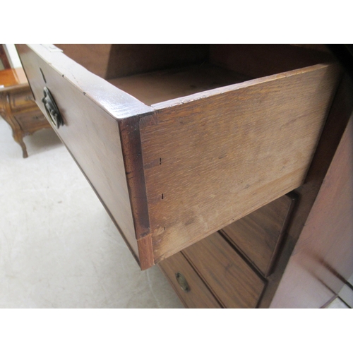 4 - An early 19thC mahogany dressing chest with two short/three graduated long drawers, raised on bracke... 