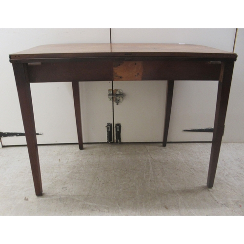 5 - A Regency mahogany tea table with a foldover top, raised on square, tapered legs  29