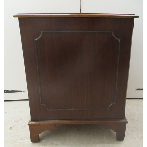 9 - A modern mahogany finished two drawer filing cabinet, the top set with a tooled brown hide scriber, ... 