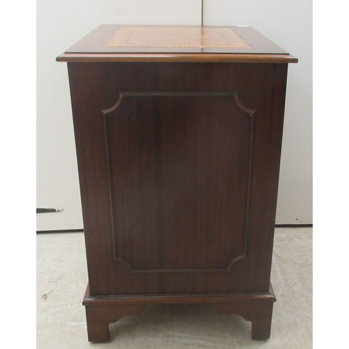 9 - A modern mahogany finished two drawer filing cabinet, the top set with a tooled brown hide scriber, ... 