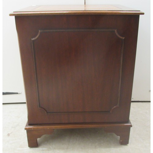 9 - A modern mahogany finished two drawer filing cabinet, the top set with a tooled brown hide scriber, ... 