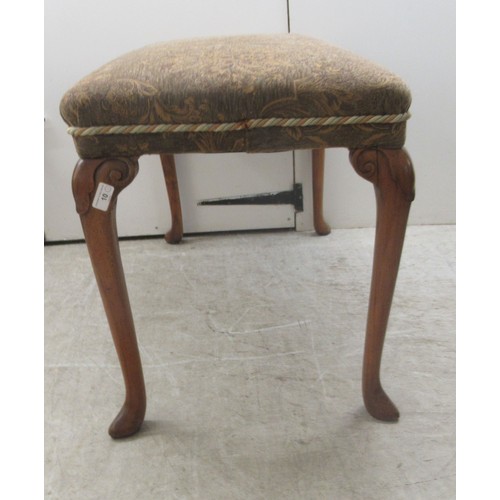 10 - A 1930s walnut framed stool with a tapestry upholstered top, raised on cabriole legs