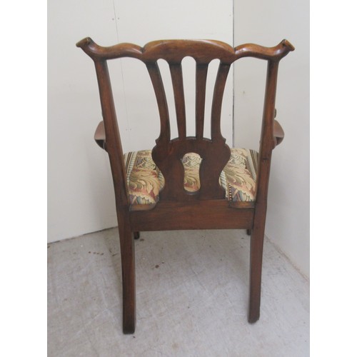 26 - A George III walnut framed, pierced splat back elbow chair, the drop-in seat raised on square forele... 