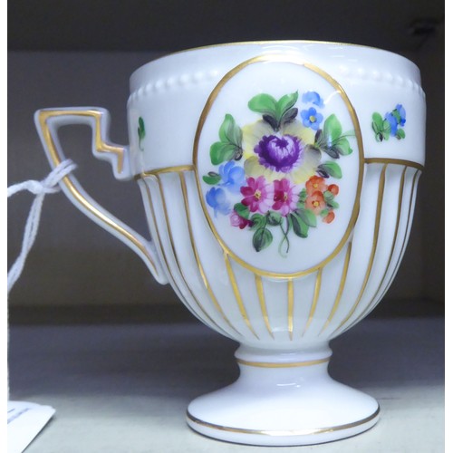 116 - A Herend porcelain pedestal cabinet cup and saucer, no.4985, decorated with flora and gilding