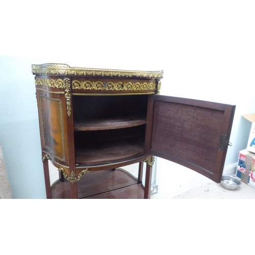 122 - A 20thC reproduction of a 19thC French side cabinet with a pierced brass gallery border, over a faux... 