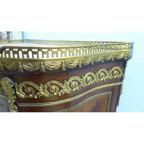 122 - A 20thC reproduction of a 19thC French side cabinet with a pierced brass gallery border, over a faux... 