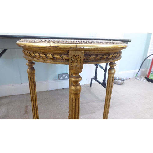 129 - A 20thC reproduction of a Continental giltwood centre table with an inset mottled marble top, over a... 