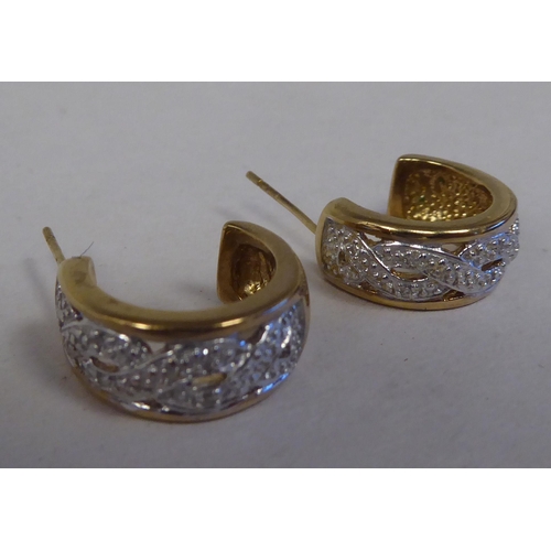 130 - A pair of 9ct gold C-shape diamond set earrings