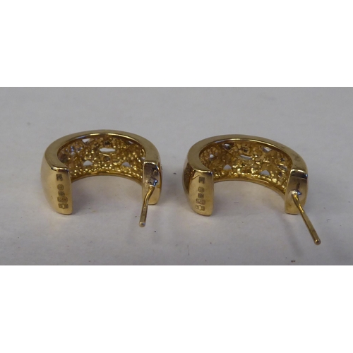 130 - A pair of 9ct gold C-shape diamond set earrings