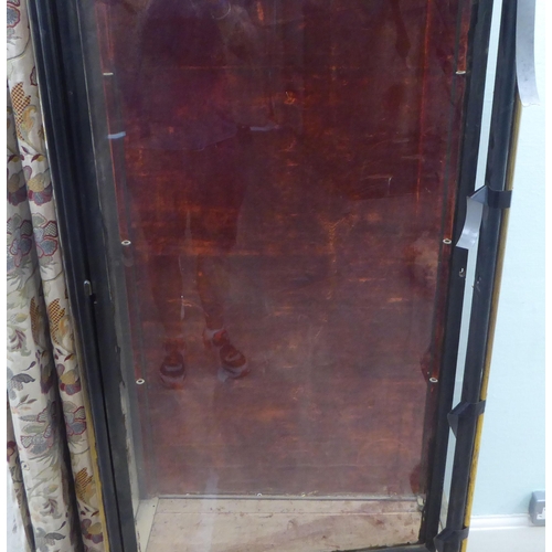 139 - A late 19thC French Empire style display cabinet, partially glazed with black and gilt trim, raised ... 