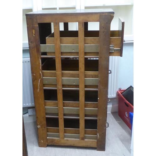 145 - A pair of 1920s oak four drawer filing cabinets, on a plinth  53