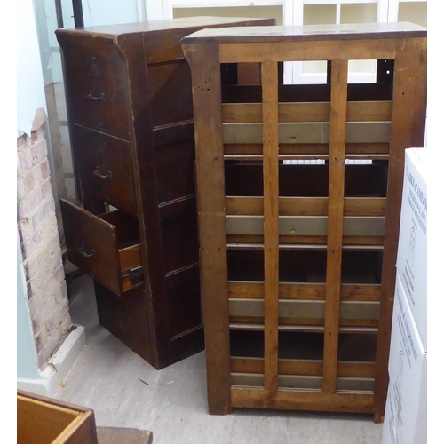 145 - A pair of 1920s oak four drawer filing cabinets, on a plinth  53