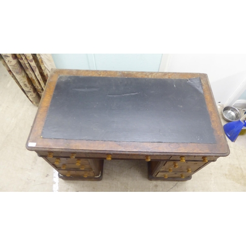 146 - A late Victorian oak nine drawer, twin pedestal desk, on a plinth  30