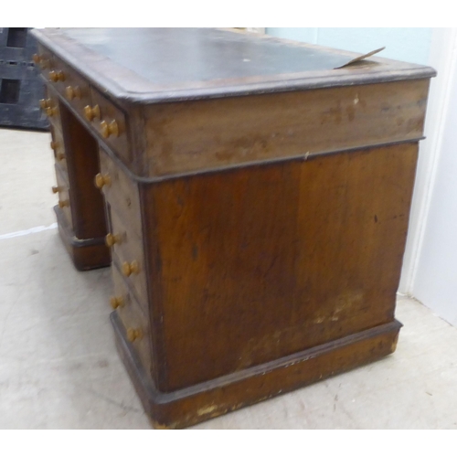 146 - A late Victorian oak nine drawer, twin pedestal desk, on a plinth  30