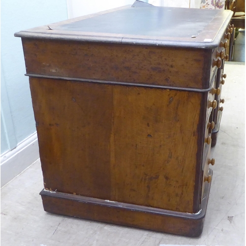 146 - A late Victorian oak nine drawer, twin pedestal desk, on a plinth  30