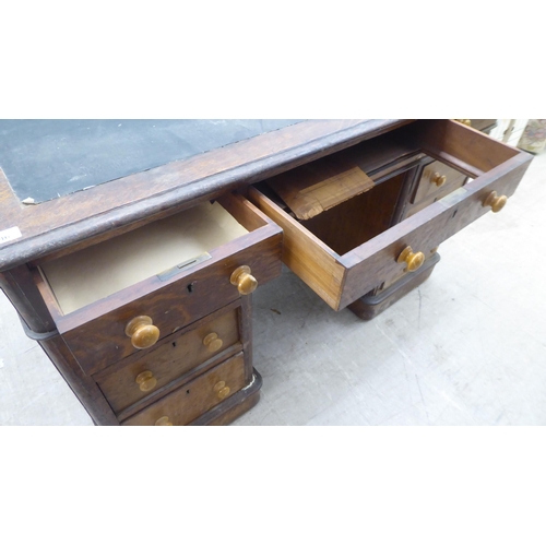 146 - A late Victorian oak nine drawer, twin pedestal desk, on a plinth  30