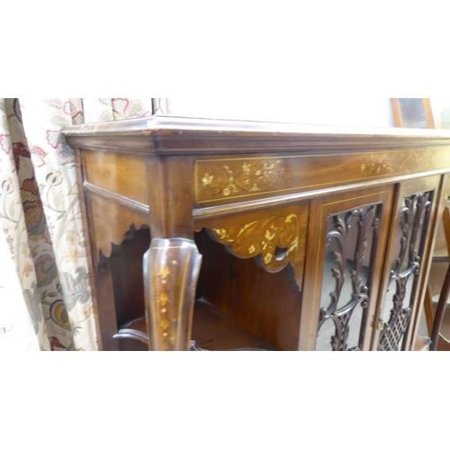 155 - An Edwardian mahogany sideboard with a pair of central glazed doors, flanked by open sections, raise... 