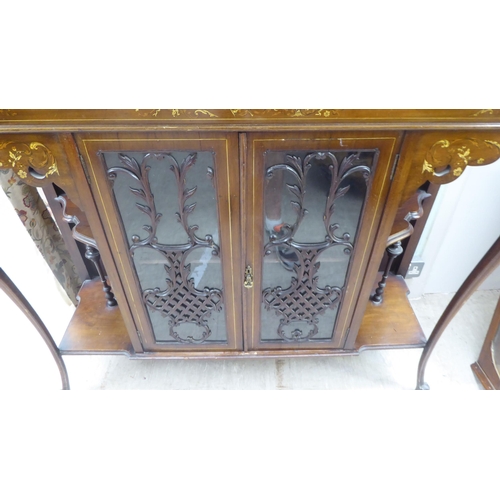 155 - An Edwardian mahogany sideboard with a pair of central glazed doors, flanked by open sections, raise... 