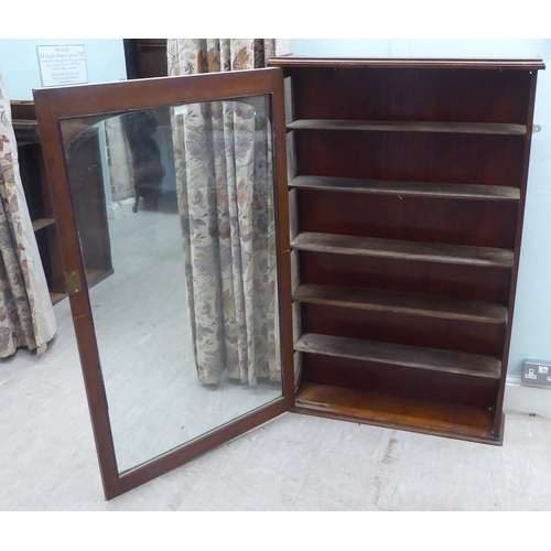 156 - A late Victorian mahogany display cabinet with a full height glazed door, on a plinth  52