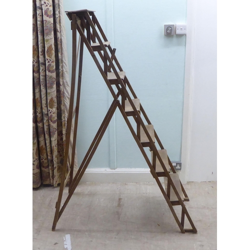 162 - A mid 20thC beech, seven tread, folding step ladder