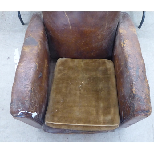 182 - An Art Deco fireside chair frame, raised on block feet