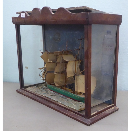 187 - An early 20thC scratch built model ship, in a partially glazed mahogany case  18