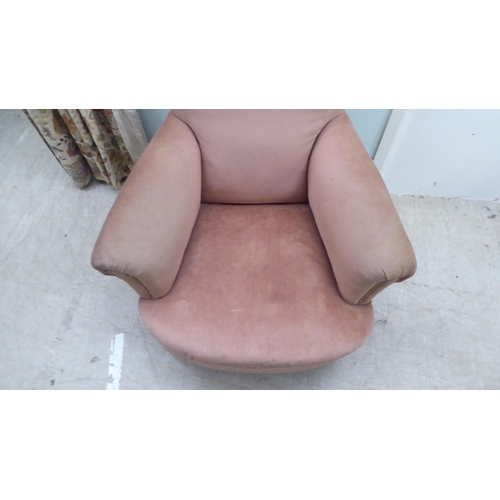 195 - A late Victorian fabric upholstered, low enclosed armchair, raised on turned forelegs 