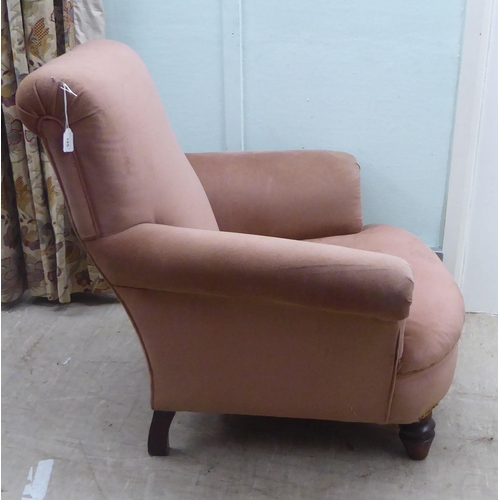 195 - A late Victorian fabric upholstered, low enclosed armchair, raised on turned forelegs 