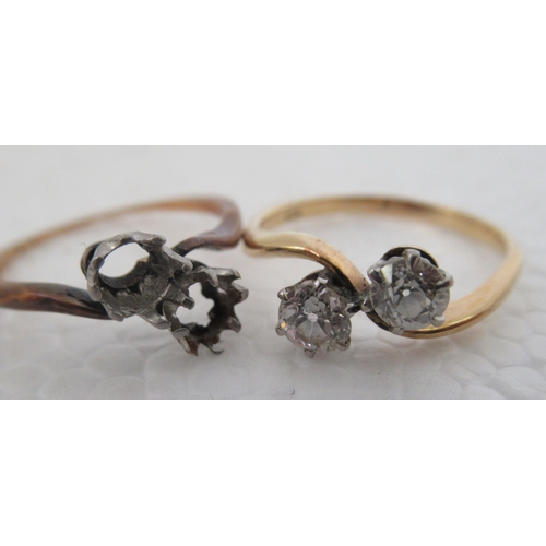 21 - An 18ct gold two stone, claw set diamond crossover ring; and another similar, but with one loose sto... 